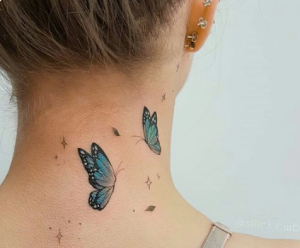 Blue butterfly group on neck female tattoo