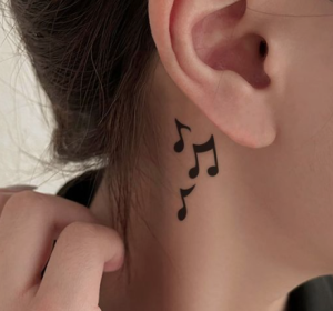 Music symbol tattoo on female neck
