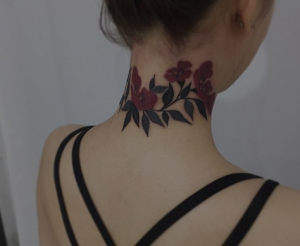 Beautiful behind the neck flower tattoo