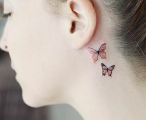 colored butterfly on a white girl neck