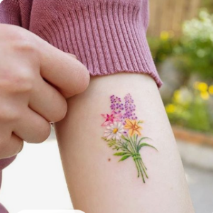 colored flower tattoo on wrist