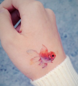 fish tattoo on wrist