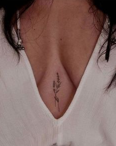 minimalist tattoo between female boobs