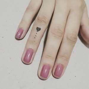 Beautiful heart and dot shaped minimalist Tattoo on girl finger