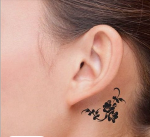 small black tattoo behind the ear
