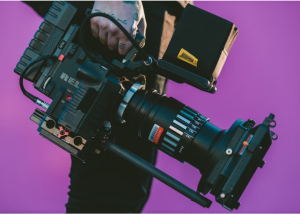 A man walking with a studio camera