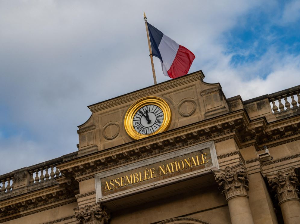 French Parliament clock at gate and national flav