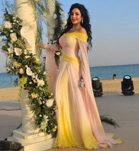 Lojain Omran Stuns in an Elegant Yellow and Pink Gown at a Beachside Celebration