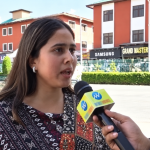 Street Interview Near Commercial Shops a Young girl speaking in front of a jounalist mike